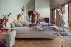 Foto van gezin die plezier heeft op de Tuur® Boxspring met het Tuur® Original Plus Matras.