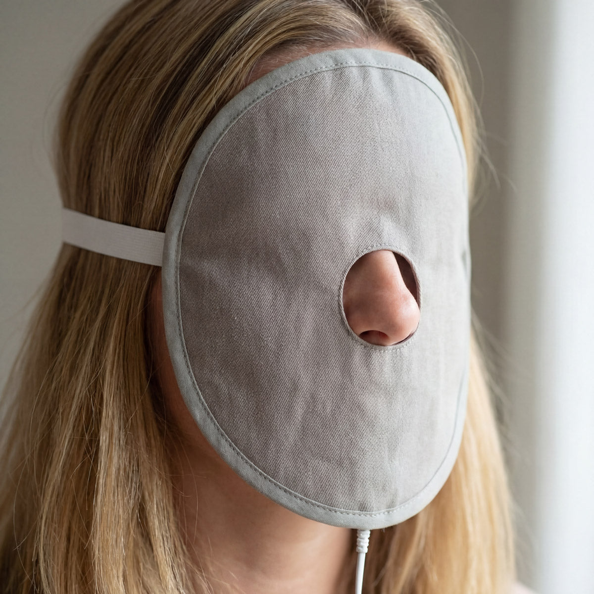 Hoofd van vrouw met Aarding™ gezichtsmasker